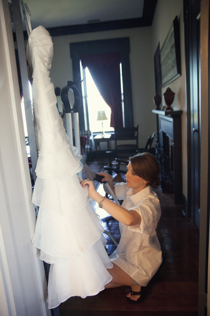 wedding planner steaming wedding dress so bride can be the bride 